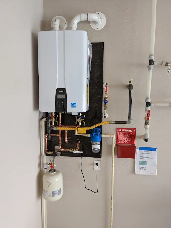 Professional plumber installing copper piping in a Tolland home